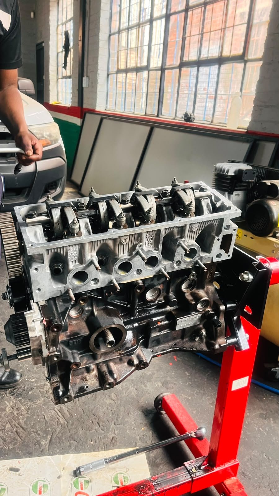 AutoKasi team member performing hands-on mechanical work